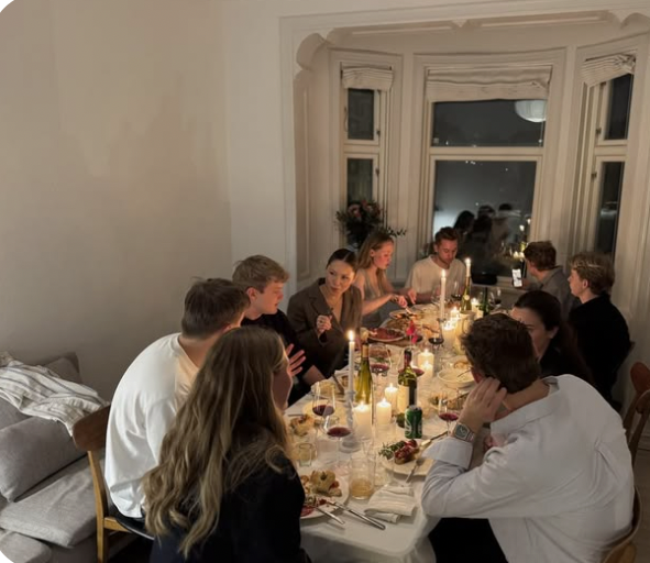 Group of tenants sharing dinner around a table