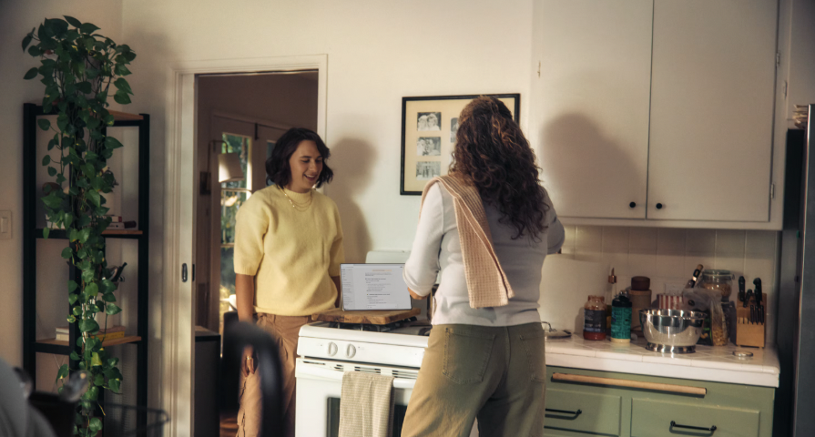Two housemates chatting in the kitchen