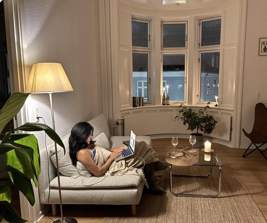 Resident working on a laptop on the living room sofa